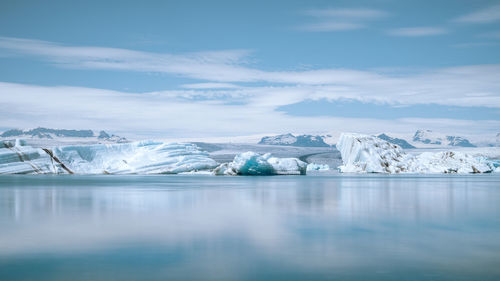 Scenic view of frozen lake against sky during winter