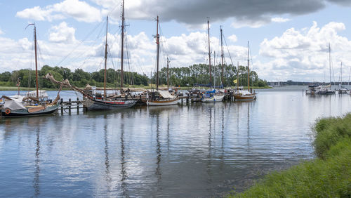 Sailboats moored in marina in maasholm, germany