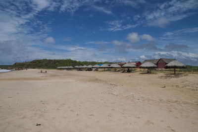 View of beach against cloudy sky