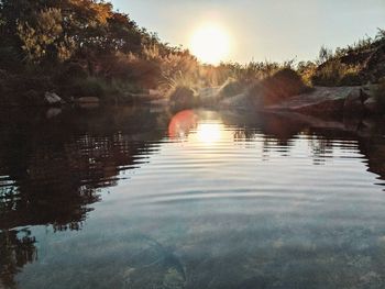 Scenic view of lake against sky during sunset