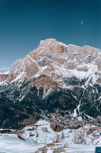 Scenic view of snowcapped mountains against clear blue sky