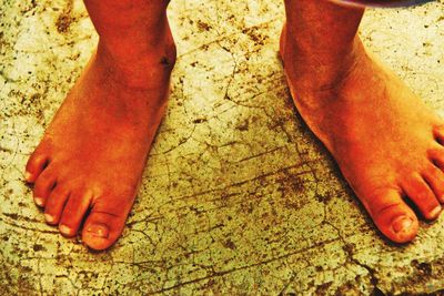 Low section of woman standing on tiled floor