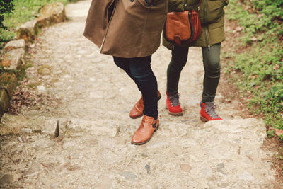 Low section of women walking on pathway