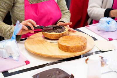 Close-up of woman holding food on table