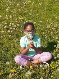 Full length of girl sitting on field