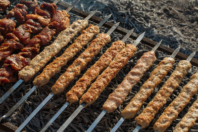 High angle view of meat on barbecue grill