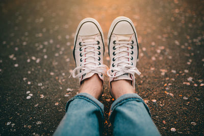 Low section of woman standing on ground