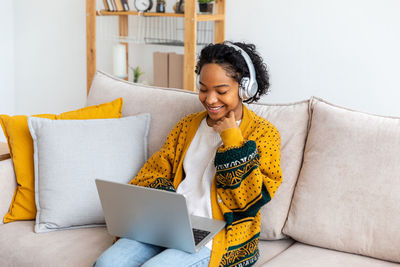 Young woman using laptop at home