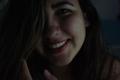 Close-up portrait of smiling young woman