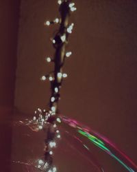 Close-up of water splashing against illuminated background