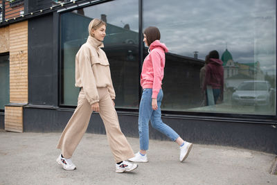 Rear view of women walking on street