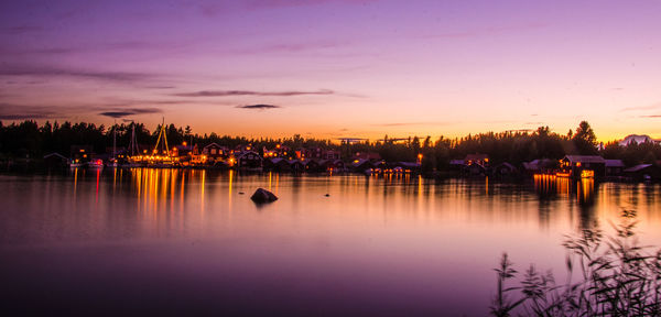 Scenic view of lake against romantic sky at sunset