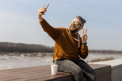 Man taking selfie on sunny day