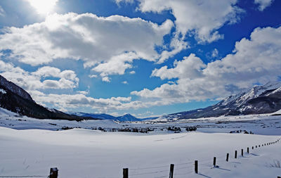 Scenic view of snow covered mountains against sky