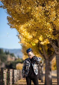 Man standing against trees during autumn