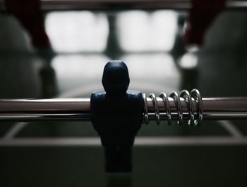 Close-up of figurine on metal rod