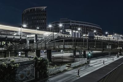 Illuminated bridge against sky at night