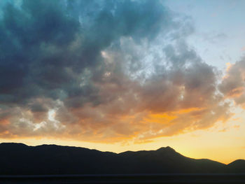 Scenic view of silhouette mountains against sky during sunset