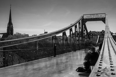 People walking on bridge in city