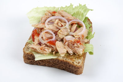 High angle view of bread in plate against white background