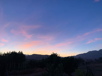 Scenic view of silhouette mountains against sky at sunset