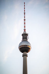 Low angle view of communications tower against sky