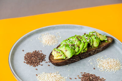 Ingredients for healthy avocado toast. sesame flax seeds. vegan keto diet. healthy eating. vegetaria