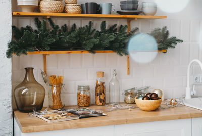 Christmas decor on the kitchen with garland. festive home interior. christmas tabletop setting over