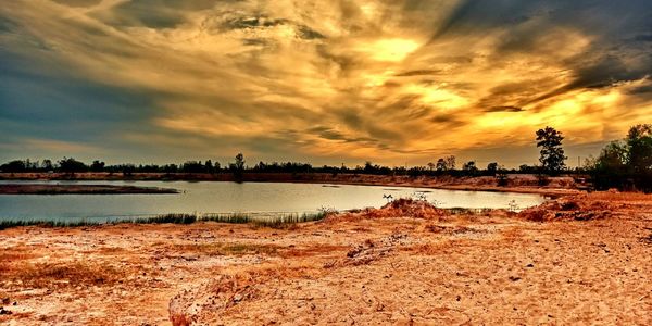 Scenic view of beach against sky during sunset