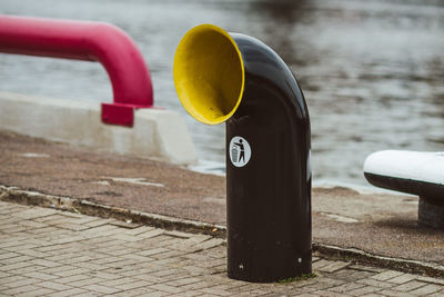 Close-up of garbage pipe at lakeshore