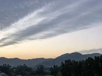 Scenic view of silhouette mountains against sky at sunset