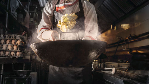 Man working in kitchen at market