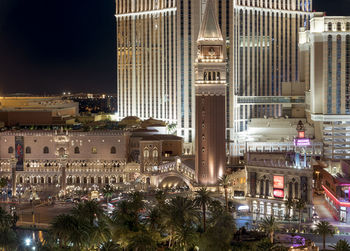 High angle view of city lit up at night