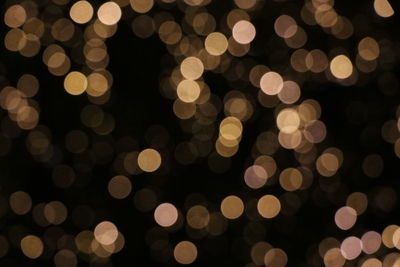 Yellow bokeh on black background - christmas pattern