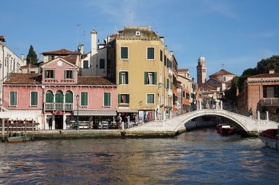 Arch bridge over grand canal in city against sky