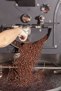 Ready-roasted coffee beans are transported to cool from the roasting machine