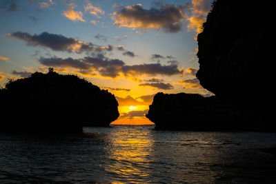 Scenic view of sea against dramatic sky during sunset