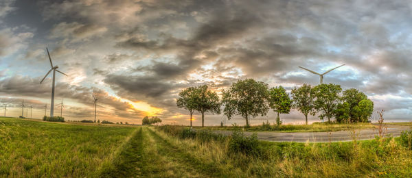 Scenic view of field against cloudy sky
