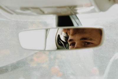 Close-up portrait of man in car