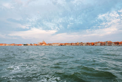 Scenic view of sea against sky in city