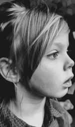 Close-up portrait of young girl looking away