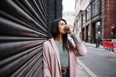 Beautiful woman standing on city street