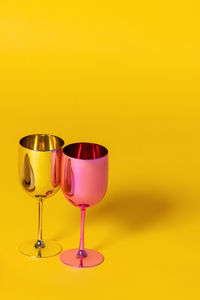Close-up of wineglass on yellow background