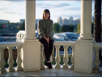 Portrait of young woman standing on terrace