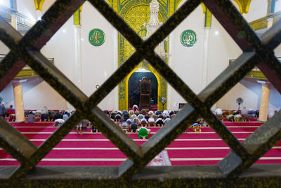 Close-up of metal fence against building