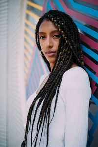 Portrait of woman against wall