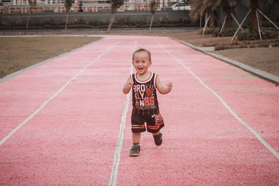 Portrait of boy standing on road