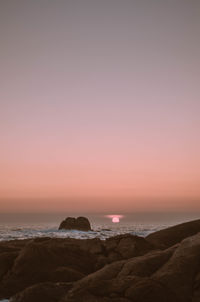 Scenic view of sea against clear sky at sunset