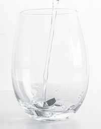 Close-up of drink in glass against white background