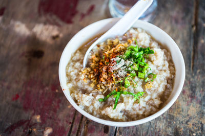 High angle view of congee in bowl on table